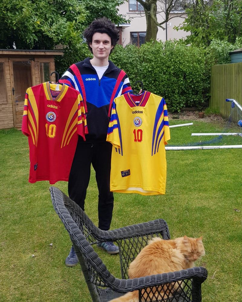 Rory in a garden holding two Romania jerseys