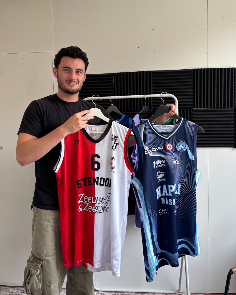 Rory holding two basketball jerseys