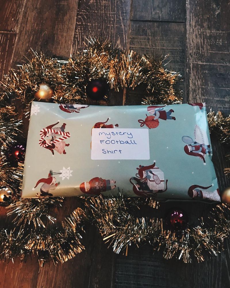 A gift-wrapped parcel labelled mystery football shirt